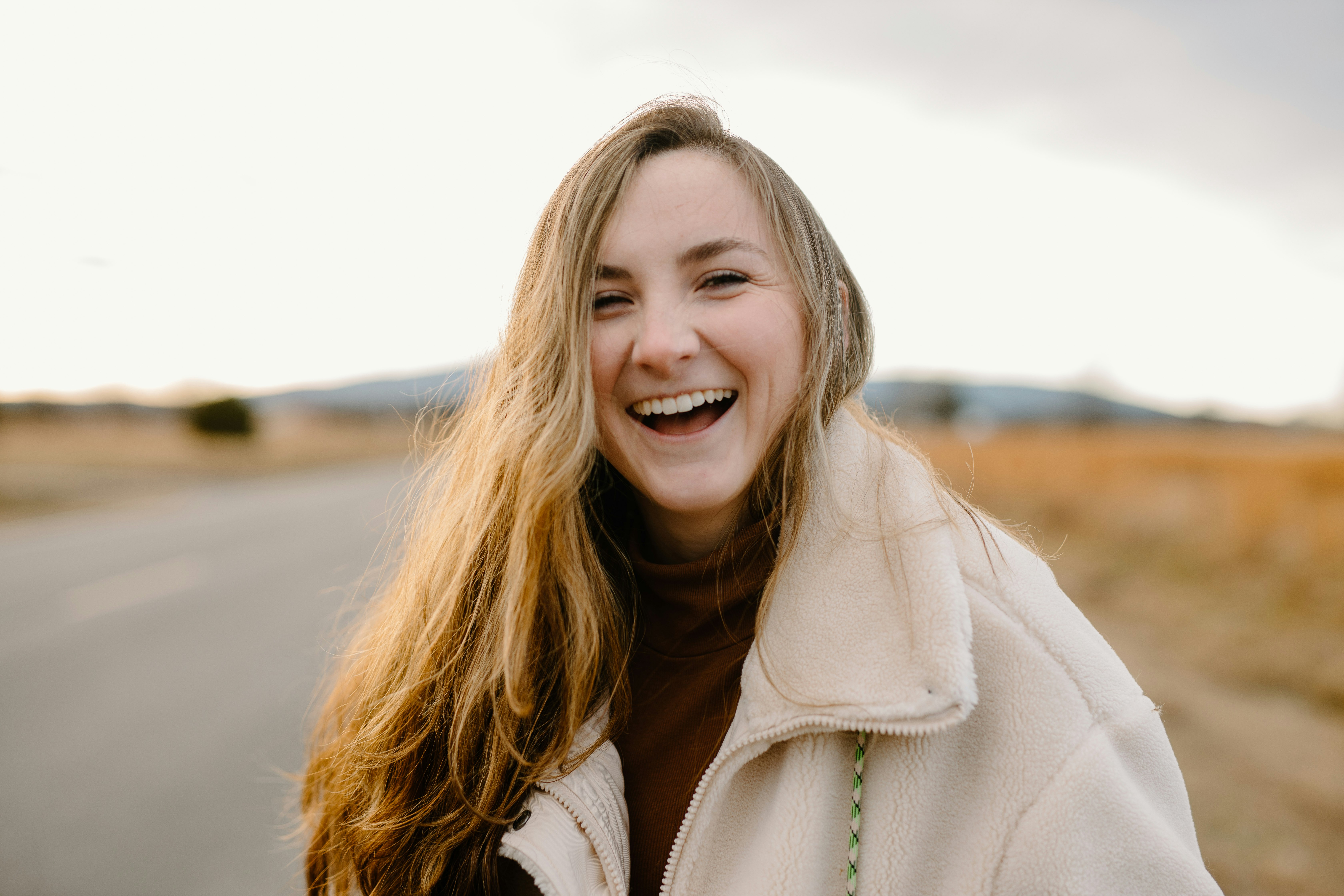 smiling woman in green jacket